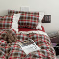 Bavarian plaid bedding set with red and brown checks and white lace ruffled trim on duvet cover and pillowcases.