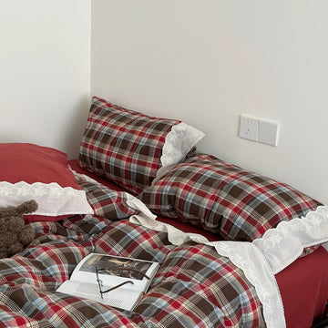 Bavarian plaid bedding set with red and brown checks and white lace ruffled trim on duvet cover and pillowcases.