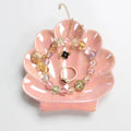 pink and white seashell shaped ceramic jewelry tray