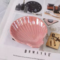 pink and white seashell shaped ceramic jewelry tray