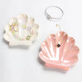 pink and white seashell shaped ceramic jewelry tray