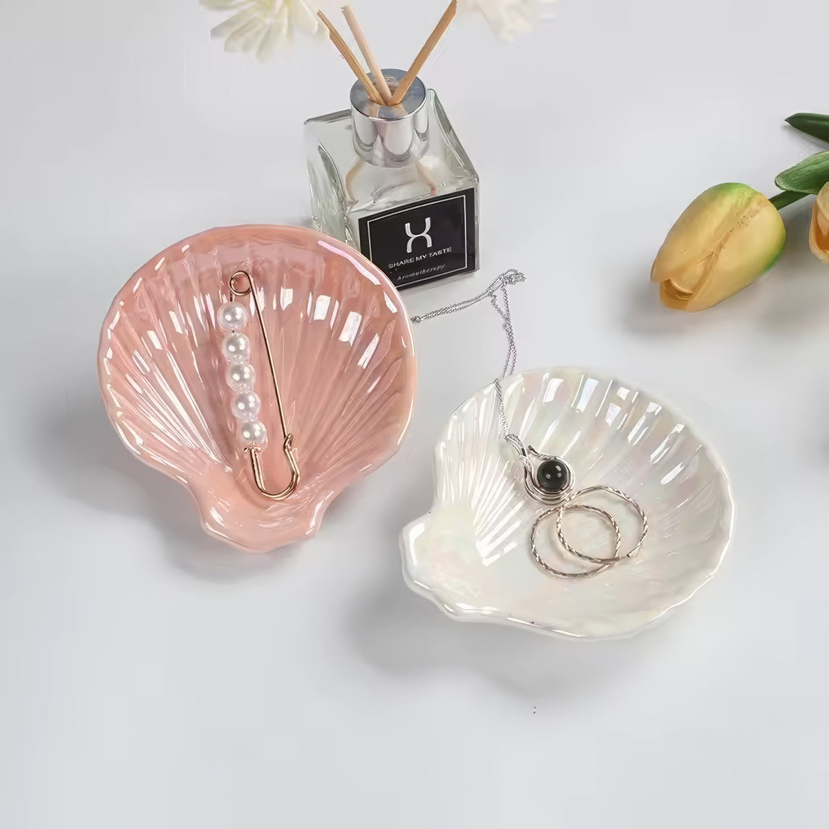 pink and white seashell shaped ceramic jewelry tray