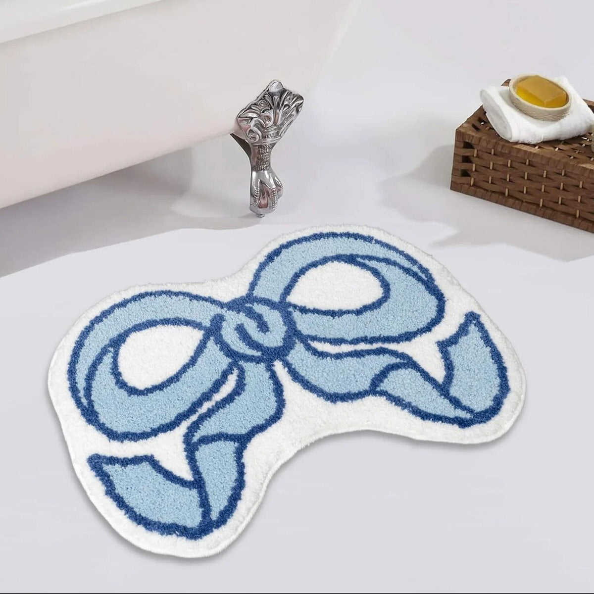 Bath mat with blue bow design on a bathroom floor
