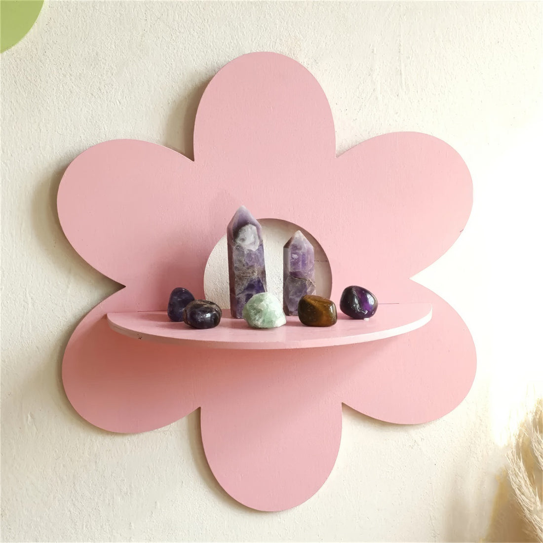 pink flower-shaped wall shelf with six rounded petals and a semi-circular shelf in the center