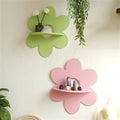 pink and green flower-shaped wall shelf with six rounded petals and a semi-circular shelf in the center