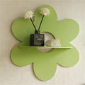 green flower-shaped wall shelf with six rounded petals and a semi-circular shelf in the center