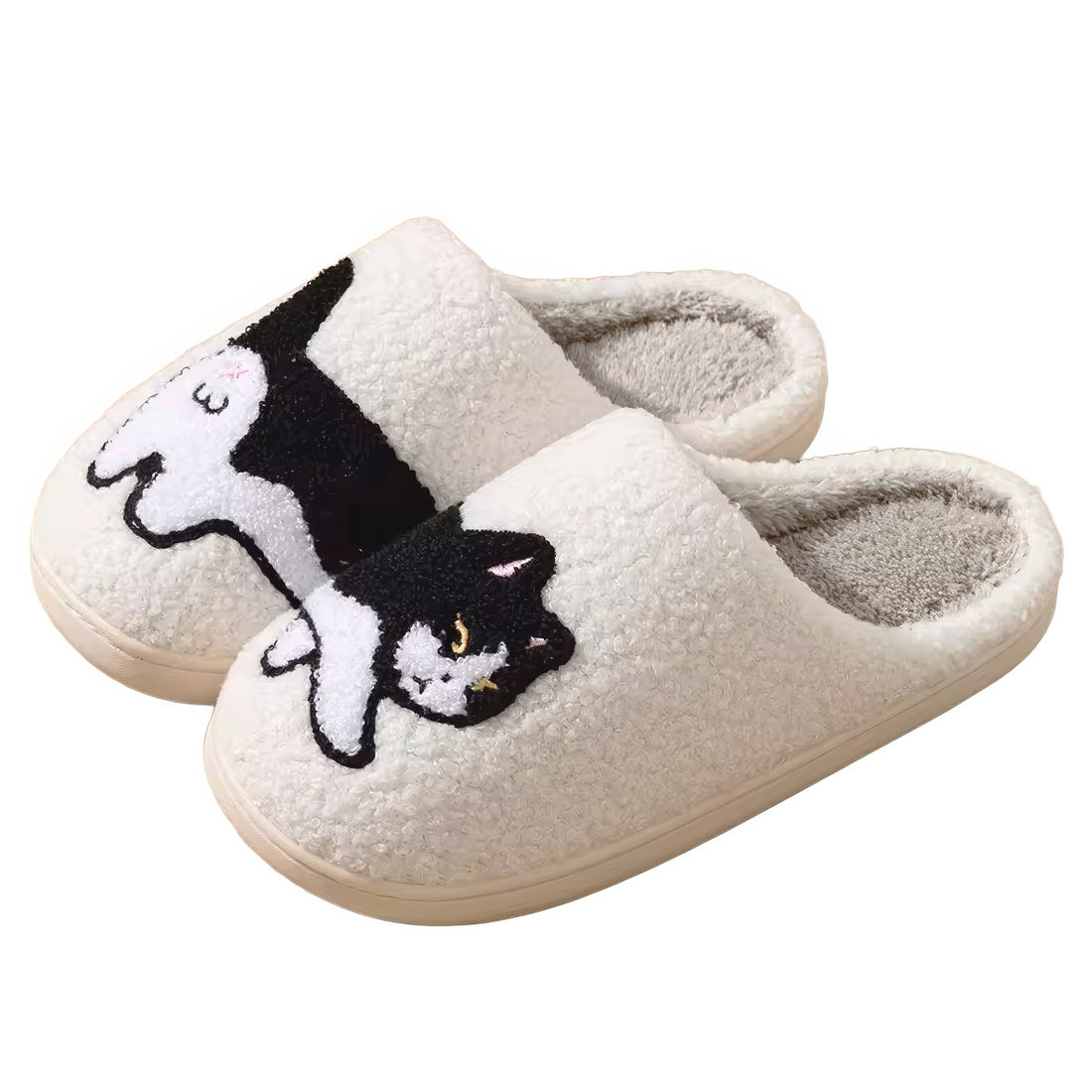 Pair of white plushie slippers with a black and white cat design