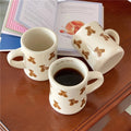 beige mug with teddy bear pattern on a white background