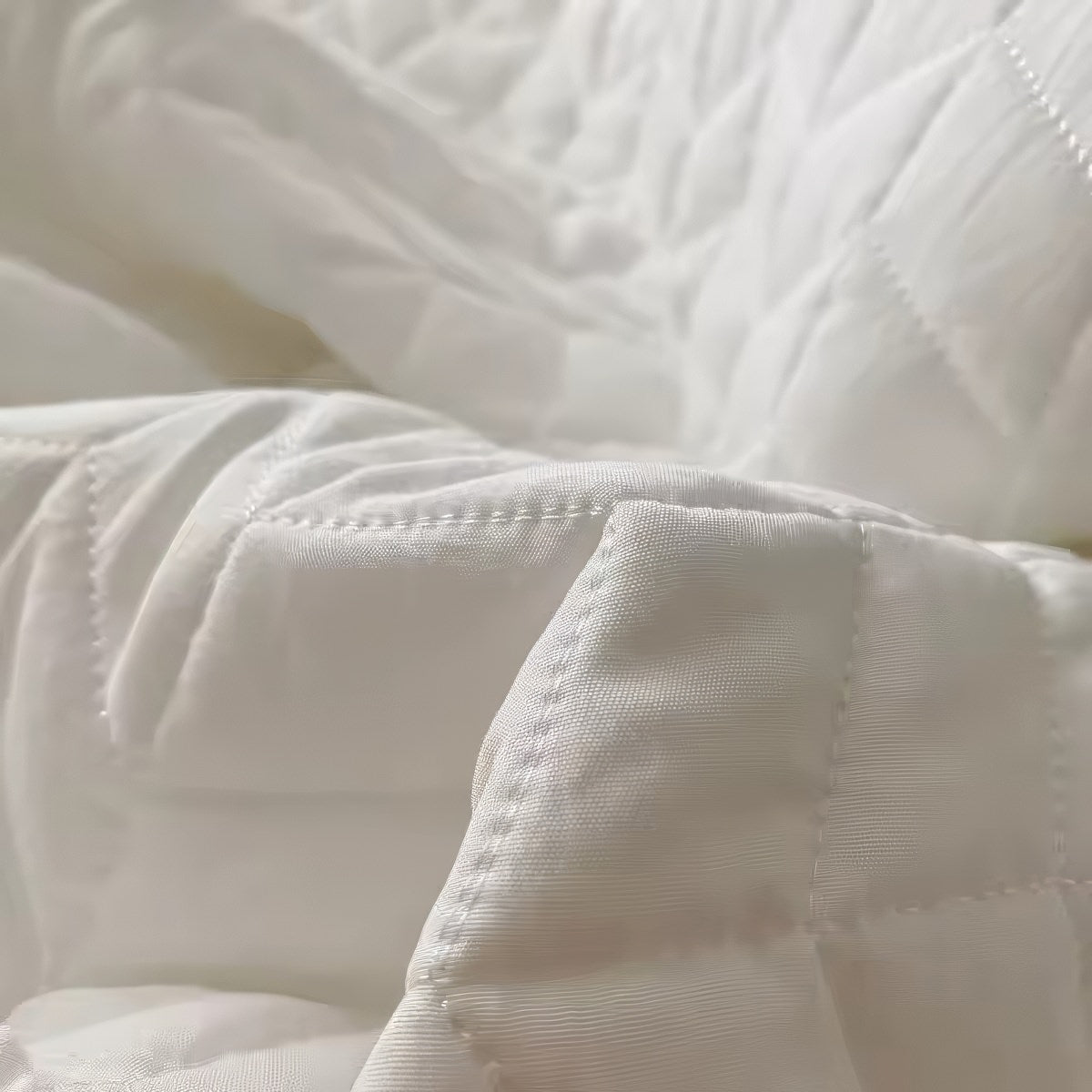 Ruffled summer quilt set with chevron stitching and ruffle trim, available in pastel and neutral colors