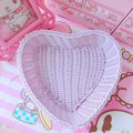 Heart-shaped pastel woven baskets in pink, mint, and lavender used for cute storage and desk organization.