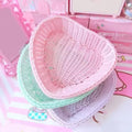 Heart-shaped pastel woven baskets in pink, mint, and lavender used for cute storage and desk organization.