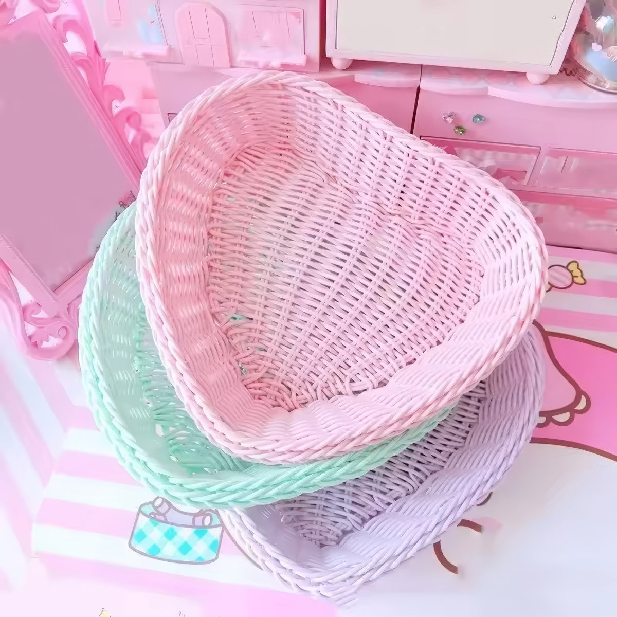 Heart-shaped pastel woven baskets in pink, mint, and lavender used for cute storage and desk organization.