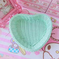 Heart-shaped pastel woven baskets in pink, mint, and lavender used for cute storage and desk organization.
