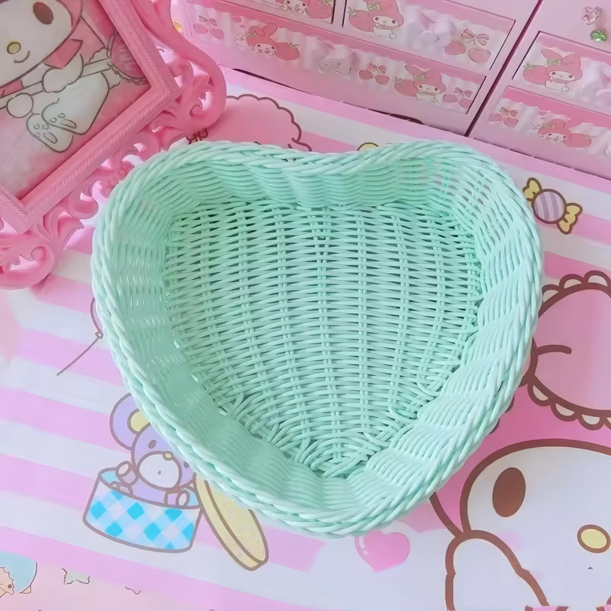 Heart-shaped pastel woven baskets in pink, mint, and lavender used for cute storage and desk organization.
