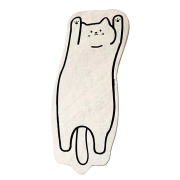 A soft, white floor mat shaped like a stretched-out cat with a simple black outline