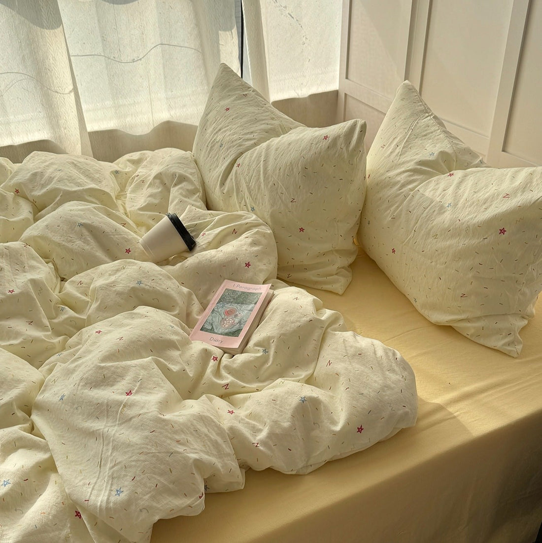 yellow creamy pastel bedding set with colorful sprinkles print pattern