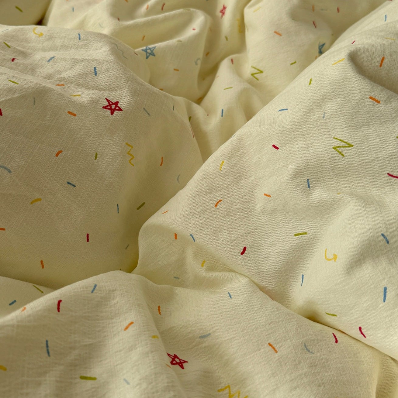 yellow creamy pastel bedding set with colorful sprinkles print pattern