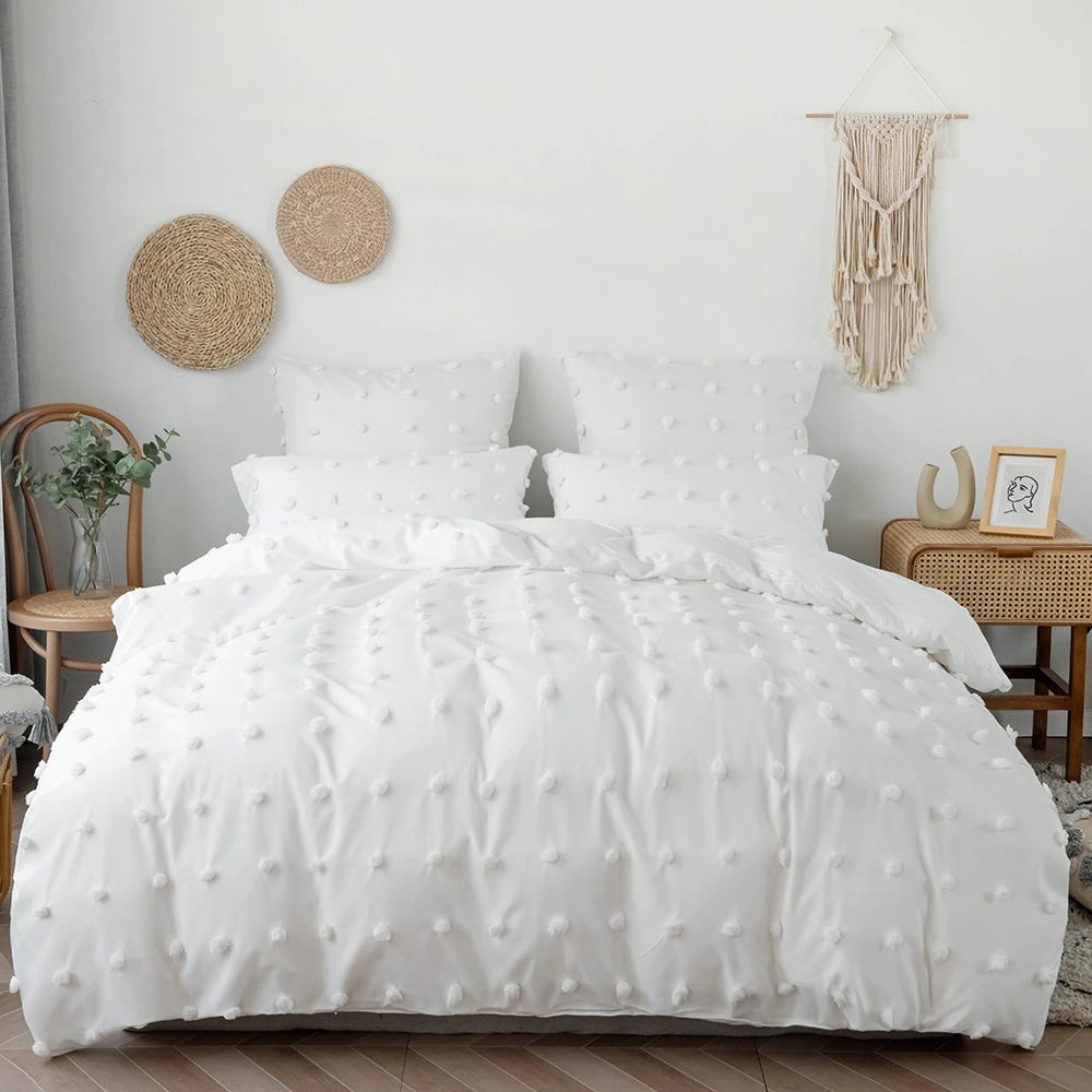http://roomtery.com/cdn/shop/products/boho-style-white-pom-pom-bedding-set-roomtery.jpg?v=1643749113