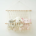 macrame wall hanging storage pocket for books and toys roomtery