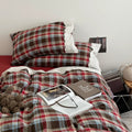 Bavarian plaid bedding set with red and brown checks and white lace ruffled trim on duvet cover and pillowcases.