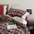 Bavarian plaid bedding set with red and brown checks and white lace ruffled trim on duvet cover and pillowcases.