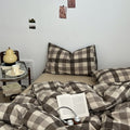 Neutral-toned gingham check bedding set in brown and beige with pillows and cozy duvet cover 