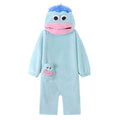 A green plush hooded one-piece pajama or costume with a frog-like face, large white eyes, a pink mouth, and a small matching frog patch on the chest