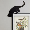 black cat silhouette pouncing on door frame minimalist decor