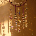 Crystal dreamcatcher wall hanging with prism beads, star charms, and sun-catching crystal strands in ivory and pink designs.