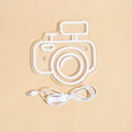 camera-shaped wall neon sign with pastel pink and blue glowing