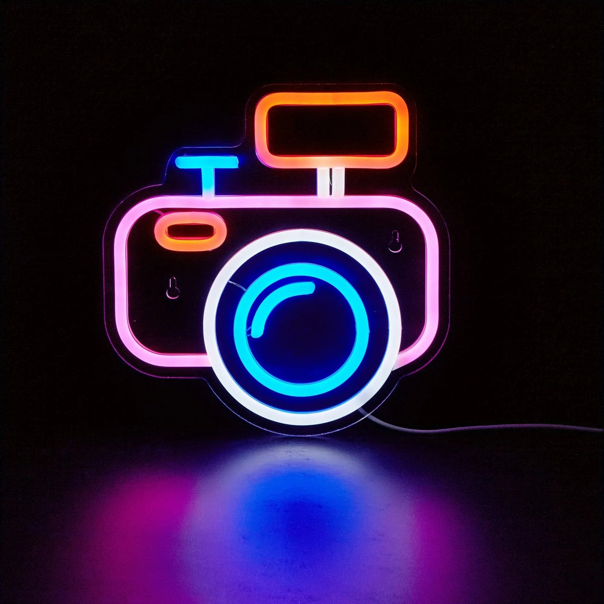 camera-shaped wall neon sign with pastel pink and blue glowing