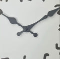 Round cartoon doodle wall clock with hand-drawn style numbers and sketch-like outline in black and white.