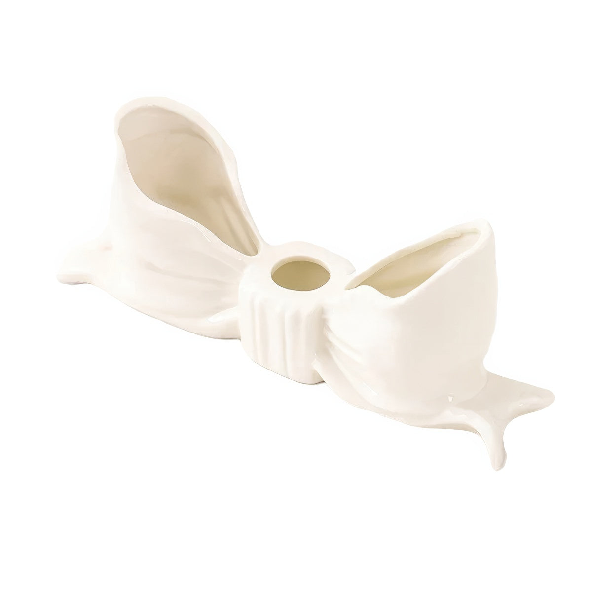 Ceramic bow-shaped candle holder in pink, red, and white with a glossy finish, designed to hold taper candles; decorative and elegant for home decor.