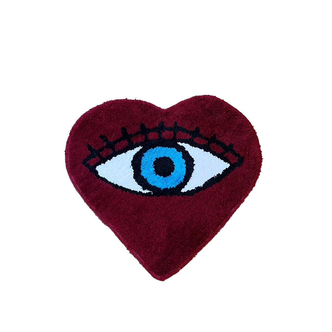 Heart-shaped dark red tufted rug with a large blue evil eye design and black lashes