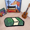 Tufted area rug designed as a stack of green dollar cash bills with a cream paper band