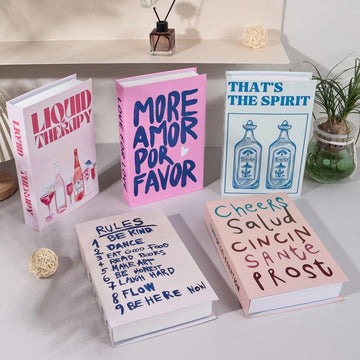 Decorative faux book storage box designed as a colorful hardcover book with a hidden storage compartment for organizing small household items while decorating shelves and tables