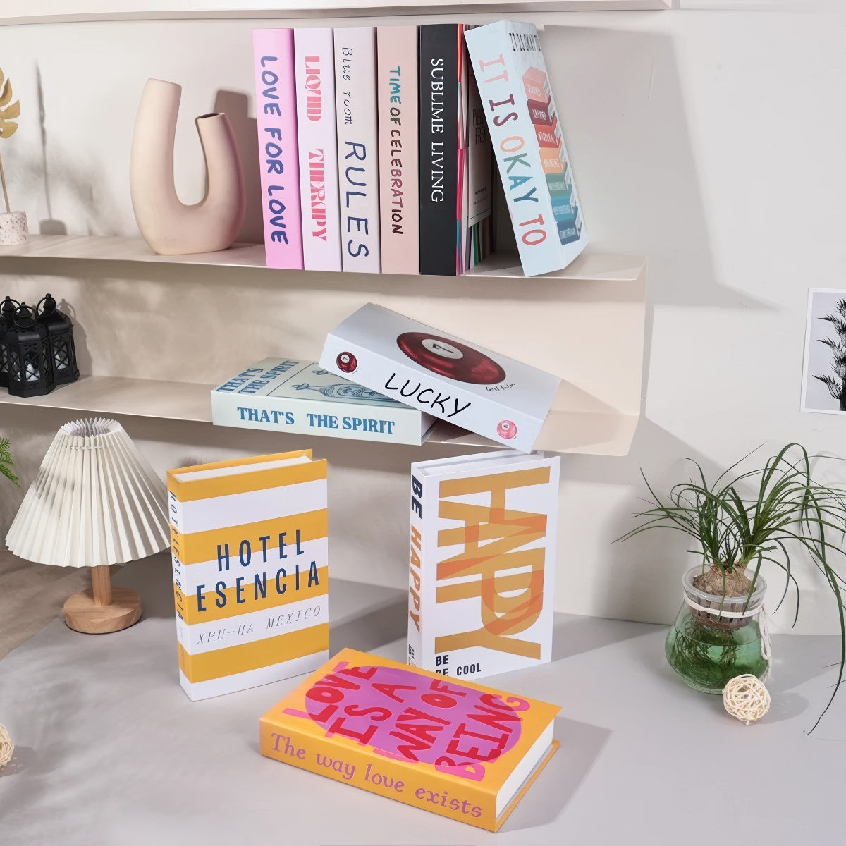 Decorative faux book storage box designed as a colorful hardcover book with a hidden storage compartment for organizing small household items while decorating shelves and tables