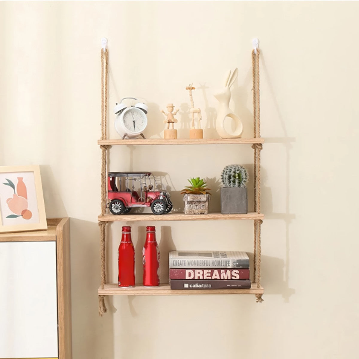 A rustic wooden shelf suspended by two thick natural-fiber rope hangers with knots