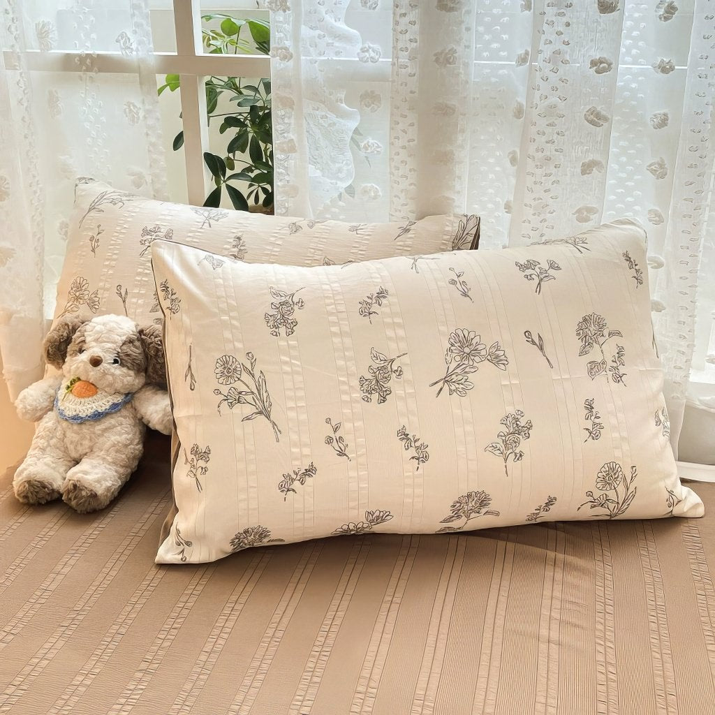 light brown floral print on a creamy and brown textured duvet cover bedding set