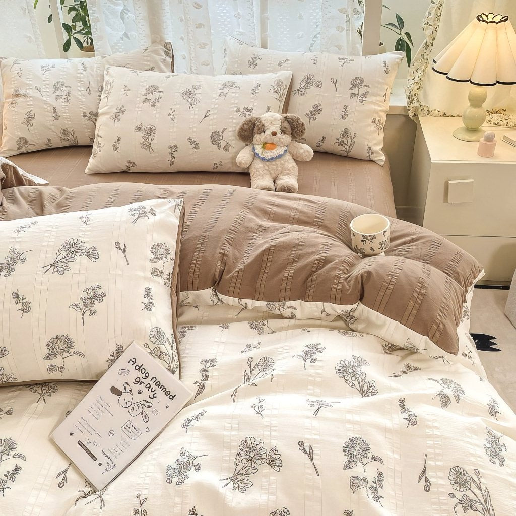 light brown floral print on a creamy and brown textured duvet cover bedding set