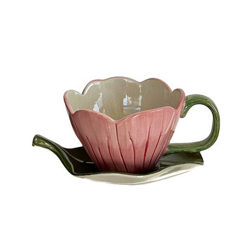blooming pink flower shaped cup with green leaf shaped saucer