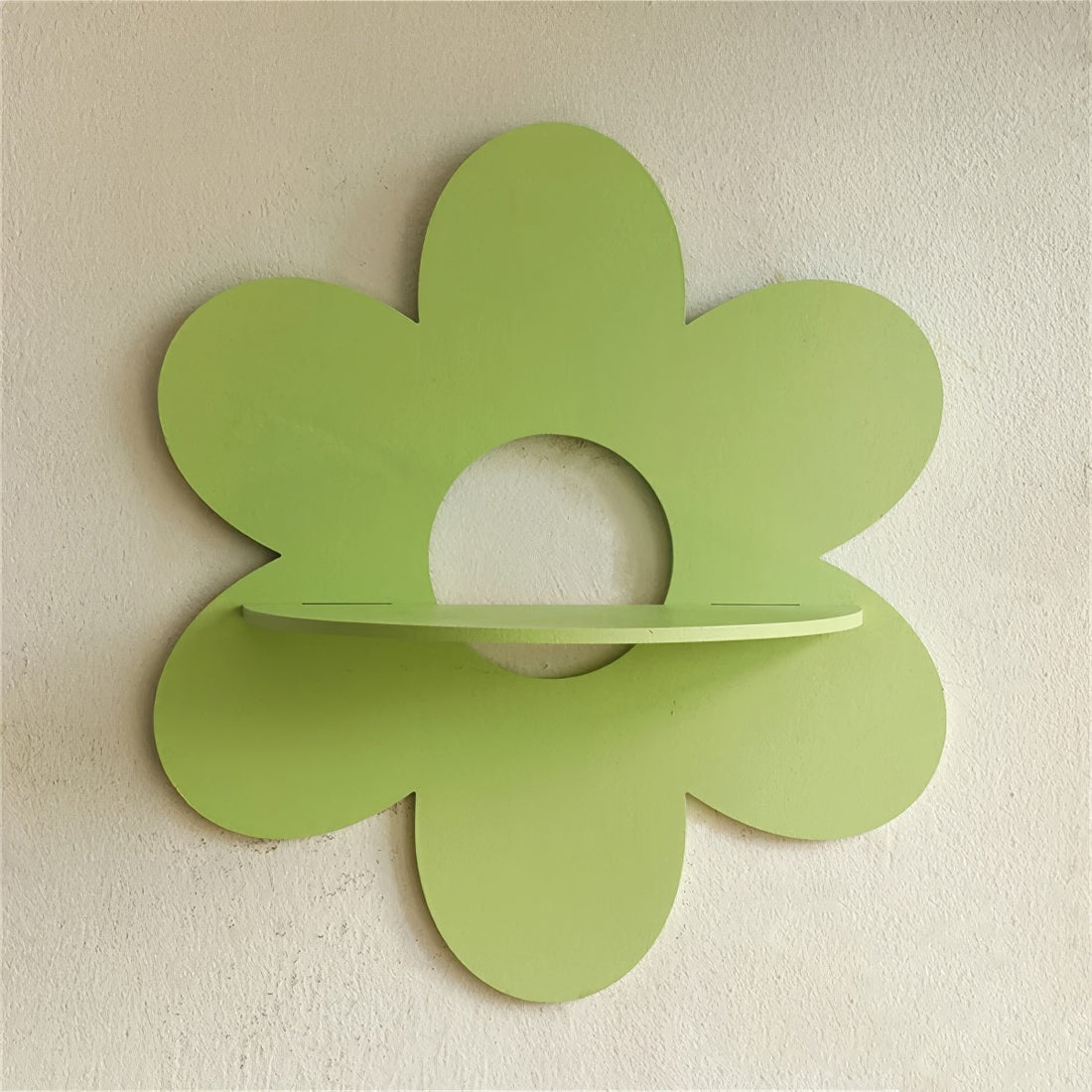 green flower-shaped wall shelf with six rounded petals and a semi-circular shelf in the center