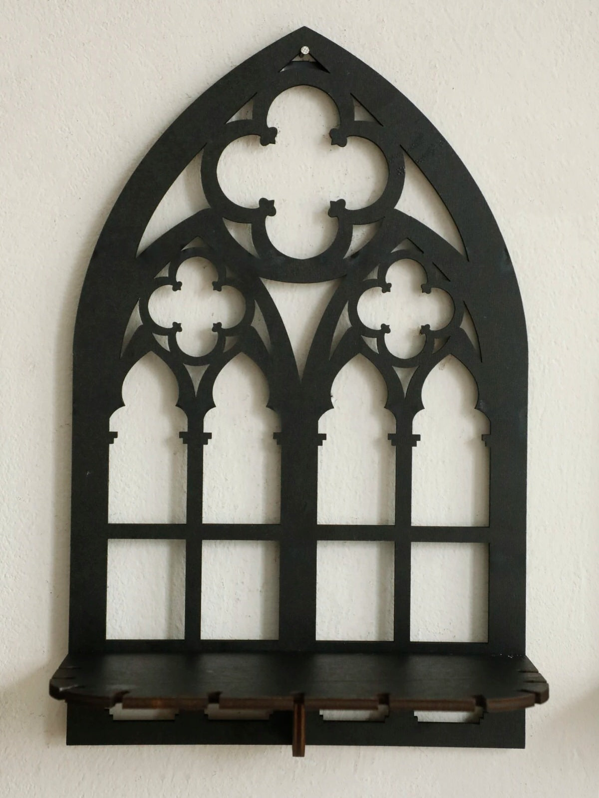 Three gothic-style black wooden wall display shelf candle holders