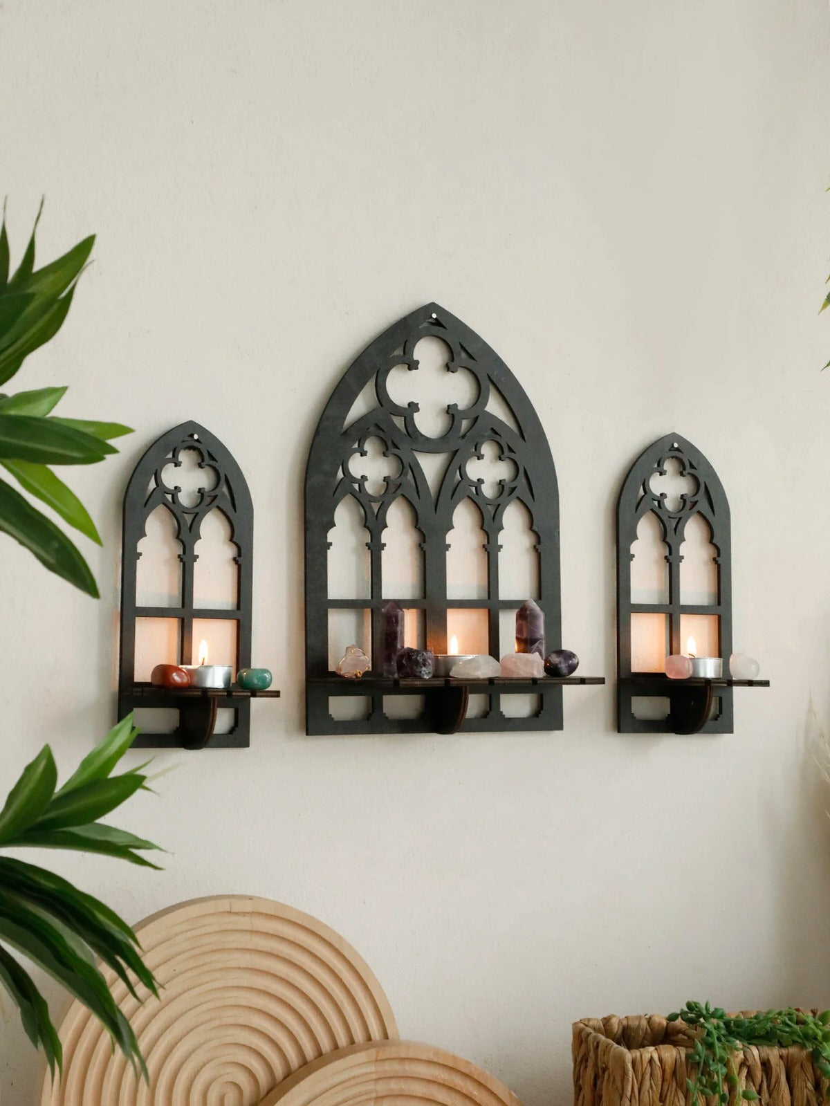 Three gothic-style black wooden wall display shelf candle holders