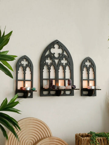 Three gothic-style black wooden wall display shelf candle holders