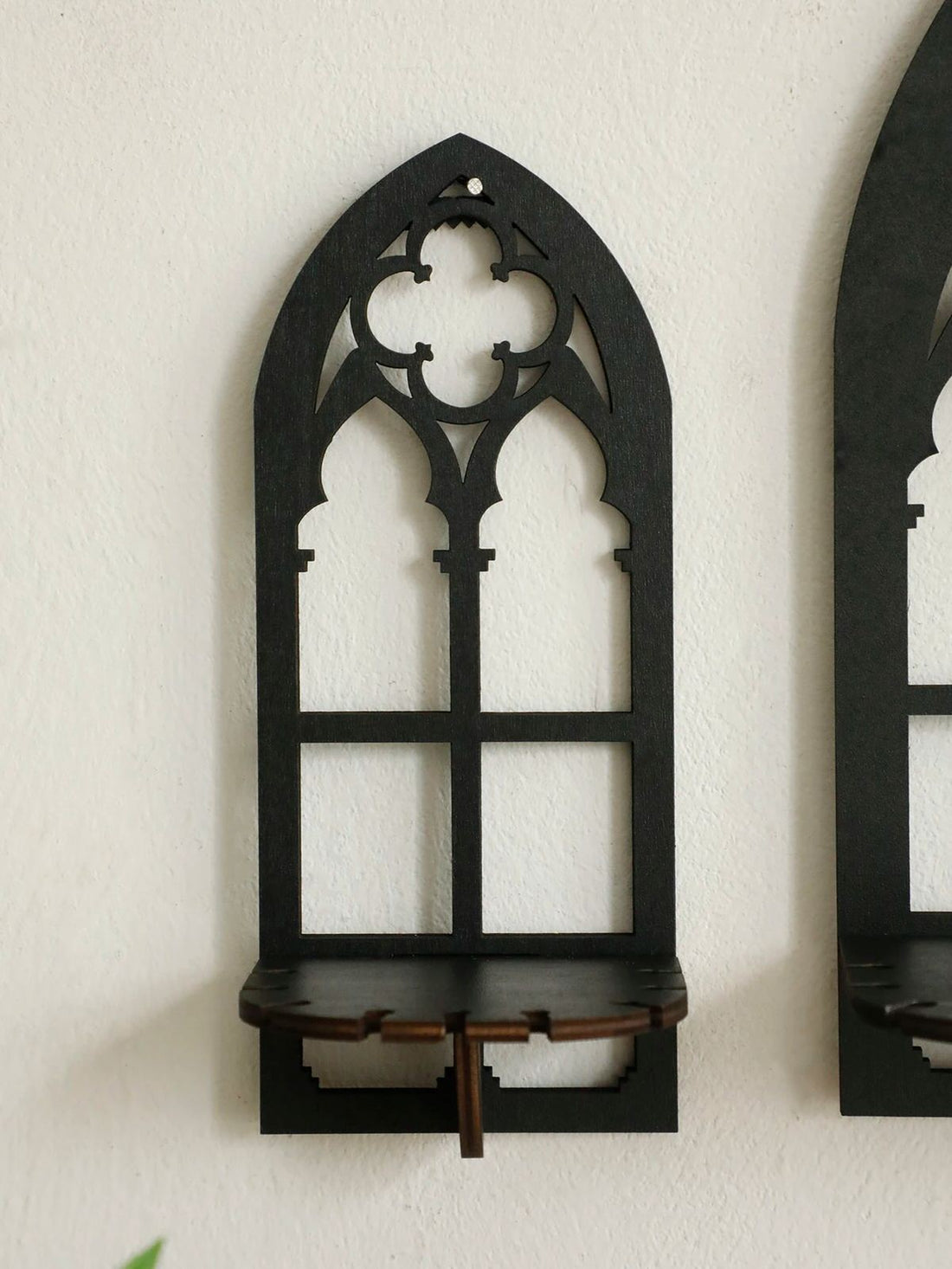 Three gothic-style black wooden wall display shelf candle holders