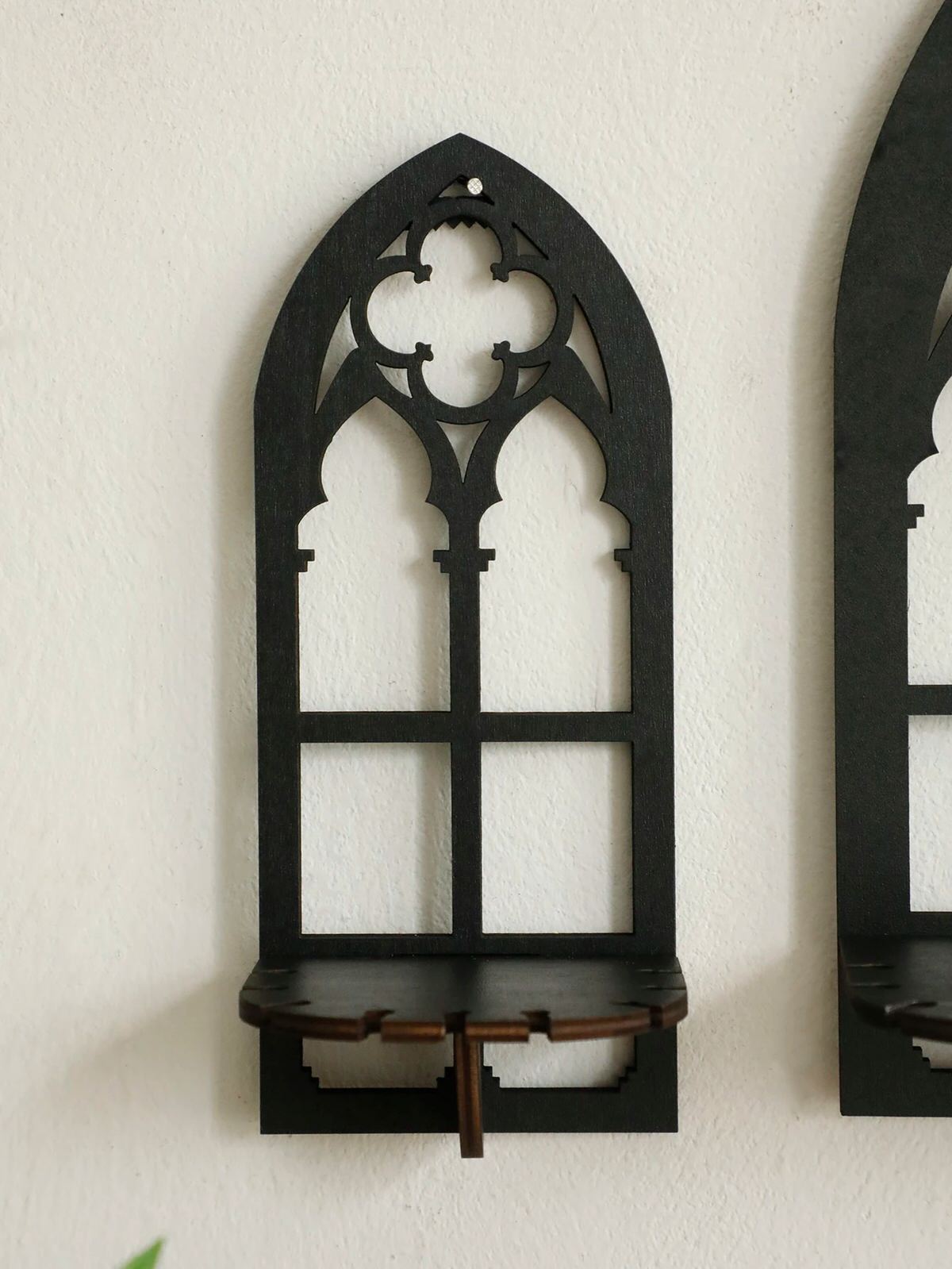 Three gothic-style black wooden wall display shelf candle holders
