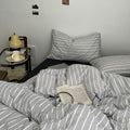 Minimalist grey and white striped duvet cover set with matching pillows and dark flat or fitted sheet set