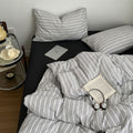 Minimalist grey and white striped duvet cover set with matching pillows and dark flat or fitted sheet set
