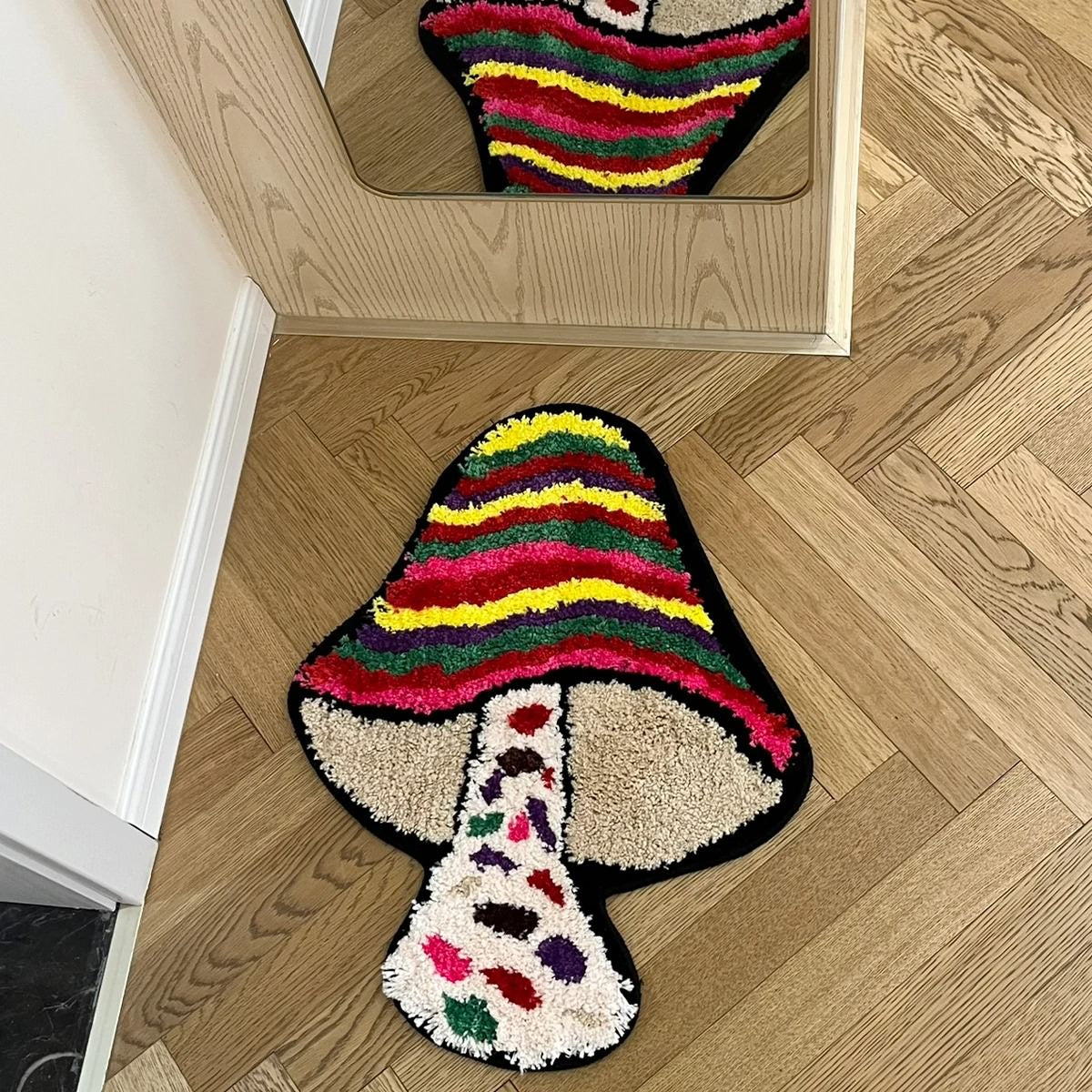 Colorful mushroom-shaped tufted rug with indie aesthetic, featuring vibrant stripes and plush texture
